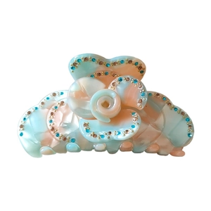 Elegant rose-shaped hair claw clip with vintage floral design and shimmering rhinestones