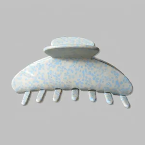 Detail of blue and white speckled acetate hair claw clip with strong spring and 7 comb teeth