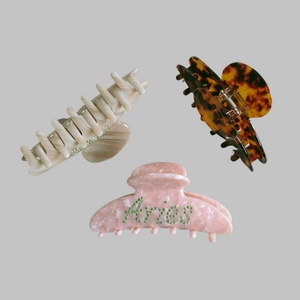 Three-piece hair claw clip set featuring Aries rhinestone letter and marble textures