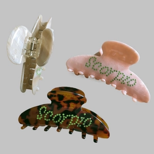 Three-piece hair claw set in marble, pink, and tortoiseshell with rhinestone Bonne text