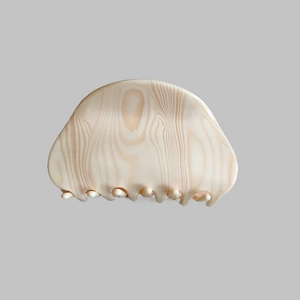 Detailed view of the checkered acetate hair claw clip with blue and beige marble texture