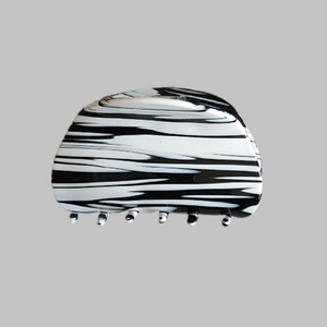 Detailed macro view of the black and white marble pattern on the acetate hair claw clip