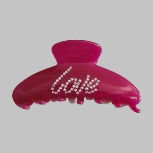 Detailed macro view of rose red hair claw clip with love rhinestone embellishments