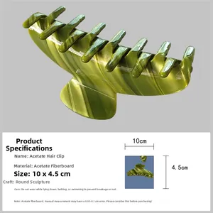 Detail view of green marble acetate shark hair claw clip with 10x4.5cm size markings