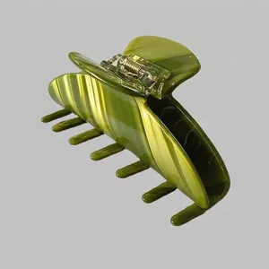 Detailed macro view of the green marble pattern acetate hair claw clip with metal spring