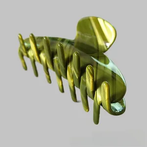 Detailed macro view of an olive green acetate claw clip with marbled texture
