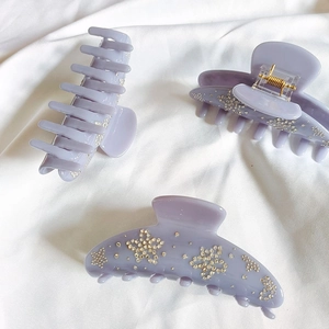 Purple flower hair claw clip with rhinestones and gold spring for elegant hair styling