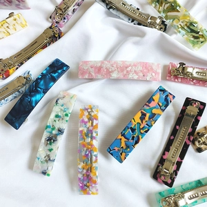 French style acetate hair clips with diverse patterns on elegant white wrinkled fabric