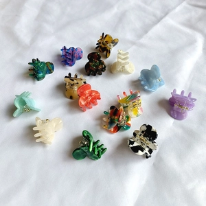Flat lay of diverse mini acetate hair claws in tortoise shell and marble patterns