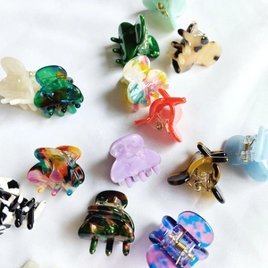 Mini acetate hair claw clips in assorted patterns like tortoise shell and marble for styling