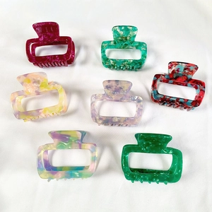 Set of seven colorful rectangular acetate hair claws with marble texture patterns