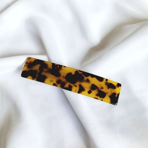 Macro detail of tortoiseshell pattern on high-quality acetate hair clip for women