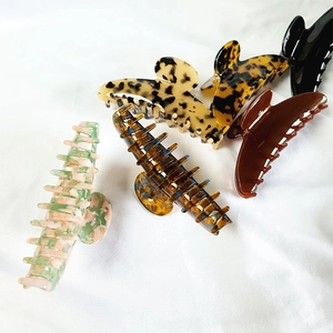 12cm French style acetate shark hair claw clips in assorted patterns on white fabric