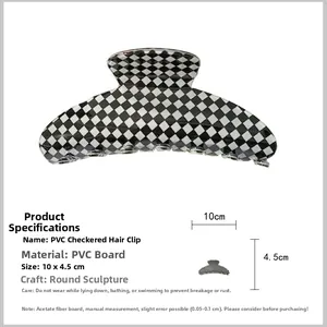 Macro shot of 10x4.5cm black and white checkered hair claw clip made of PVC acetate