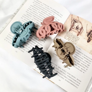 Set of four matte medium shark hair claws in grey-blue, pink, black, and khaki tones