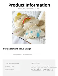 Detailed view of pearlescent acetate cloud hair clips with sun and rainbow charms on a book