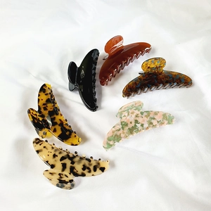 Flat lay of 6-piece large acetate hair claw set in diverse tortoise and marble patterns