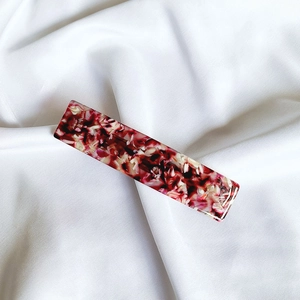 Detail of French acetate hair clip with elegant red and black marbled tortoiseshell pattern