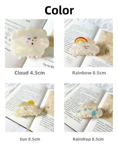Detail view of cloud-shaped acetate hair claws in four styles with rainbow and sun motifs