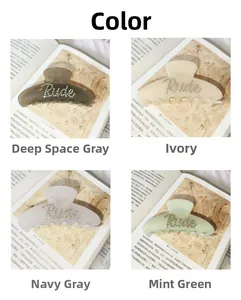 Close-up of four colors acetate hair claws with rhinestone Rude lettering on books
