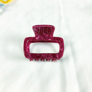 Close-up of small square acetate hair claw clip with purple marble texture pattern