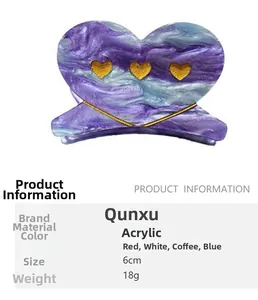 Detail view of heart-shaped acrylic hair claw with purple and blue marble pattern