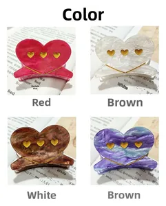 Detailed set of four acetate heart hair claws in marble, glitter, and tortoise patterns
