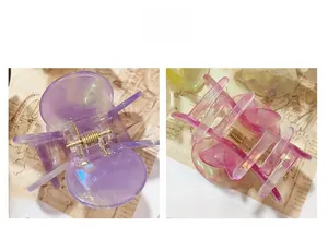 Detailed macro of translucent flower hair clips with iridescent finish and metal spring