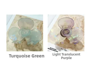 Detailed close-up of emerald green and light purple flower-shaped acetate hair claw clips