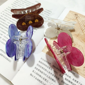 Elegant butterfly hair claws in four colors including deep brown and lavender purple