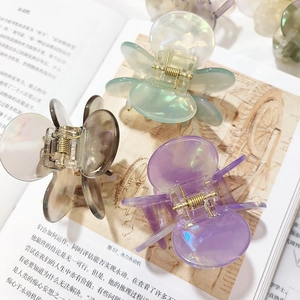 Three-piece floral hair clips in purple, green and taupe with pearlescent finish