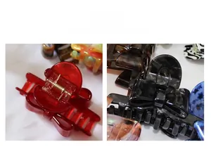 Detail view of acetate bow hair claws showing metal spring and colorful resin texture