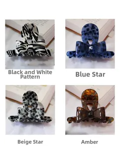 Detail showing acetate hair claws in zebra, amber, and star patterns on books