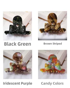 Detail of cellulose acetate hair claws in four colors: green, striped, purple, and candy