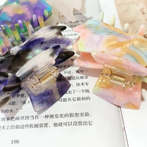 Large acetate bow hair claw clips in marble purple and colorful candy patterns