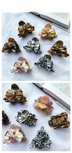 Detailed macro view of acetate claw clips in various patterns with metal springs
