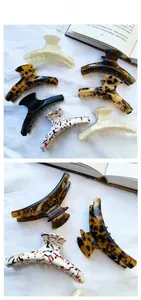 Macro detail of large acetate hair claws in tortoiseshell and solid patterns