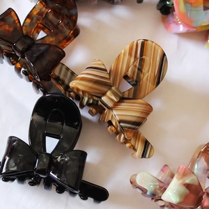 French bow acetate hair claw clips in tortoise shell and shimmering black patterns