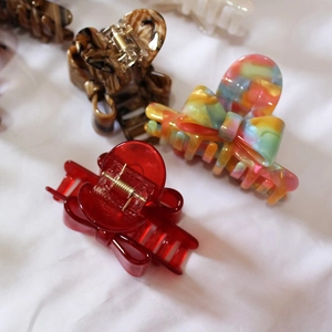 French style acetate bow hair claws in vibrant red, marble, and amber finishes