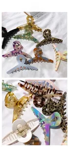 Detail of large acetate hair claws in various patterns like leopard and marble texture