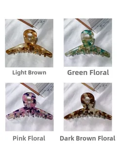 Detail view of four acetate claw clips in amber, marble green, floral pink, and coffee patterns