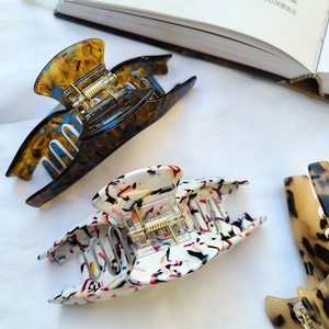 Large French acetate hair claws in tortoise shell, white ink, and leopard patterns