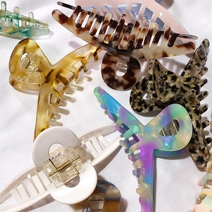 Large acetate hair claws in various patterns including marble and tortoiseshell styles