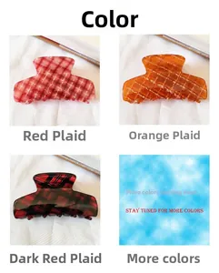 Macro detail of French red plaid hair claw clips in acetate resin with smooth polished finish
