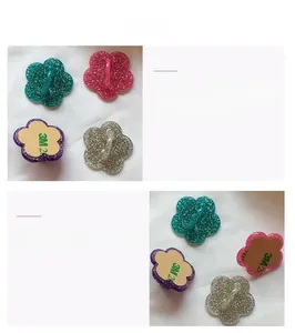 Detailed view of flower-shaped phone hooks with glitter finish and 3M adhesive backing