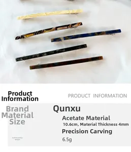 Detail view showing marble texture acetate hair clips with 10.6cm length and slim design