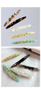 Close-up of five acetate leopard print hair clips with silver metal spring fasteners