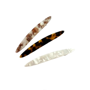 Three acetate hair clips in leopard and marble patterns with a minimalist French style