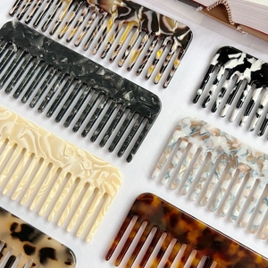Elegant cellulose acetate wide-tooth hair combs in various marble and tortoiseshell patterns
