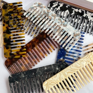 Elegant cellulose acetate wide-tooth hair combs in various marble and tortoiseshell patterns
